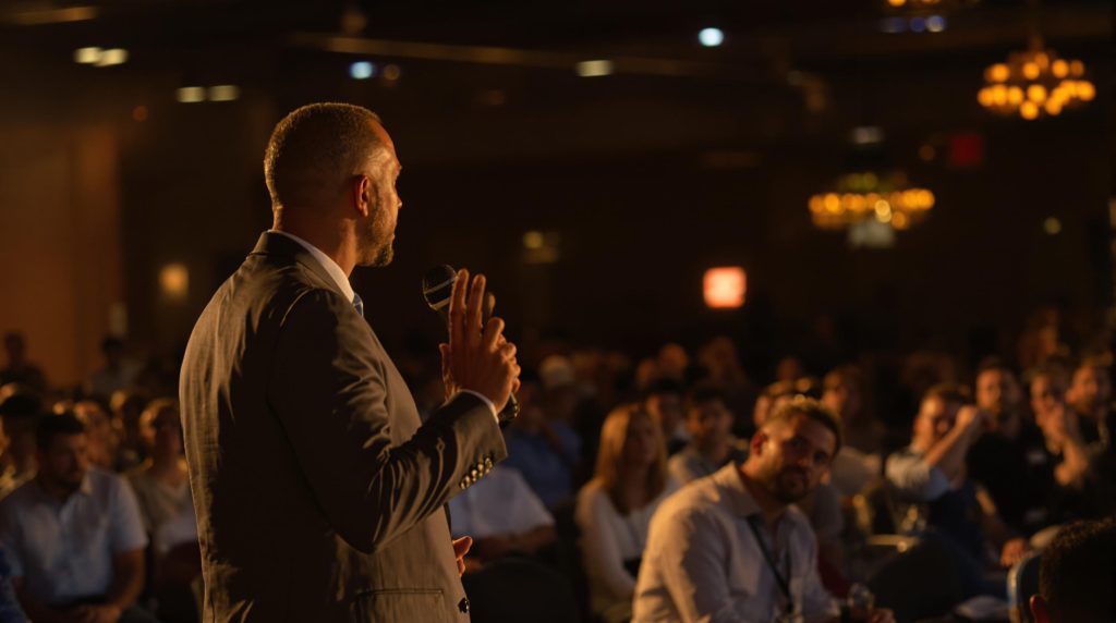 Man giving a speech to an audience.